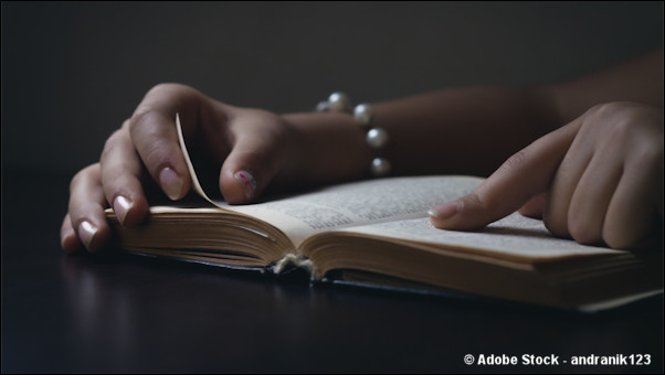Woman's hands with open Bible